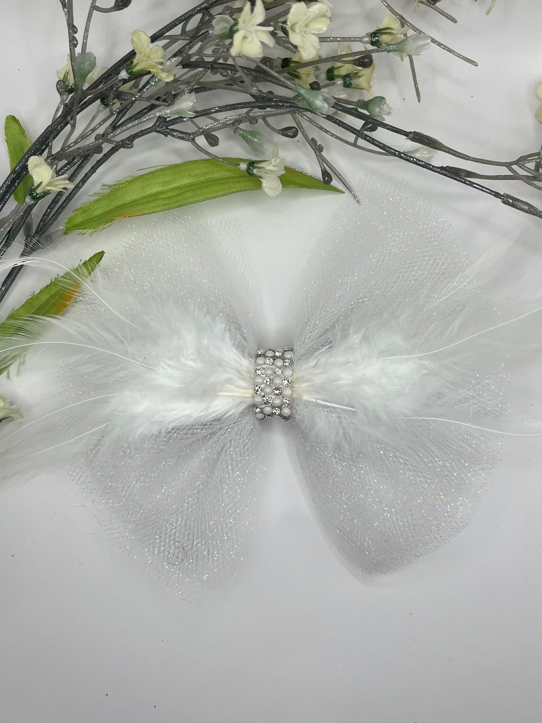 White sparkle tulle with white feathers and rhinestone center bow
